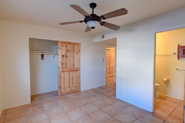 Unit 813-Bedroom one with ample closet and adjacent bathroom - 2210 Miguel Chavez Rd