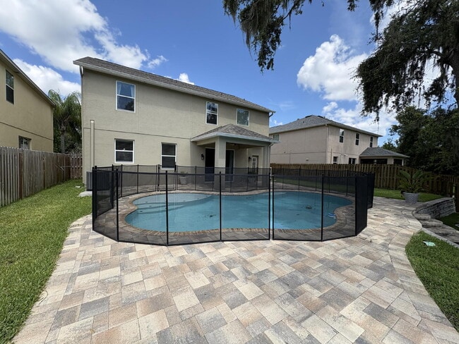 Building Photo - Spacious 5-Bedroom Pool Home with Putting ...