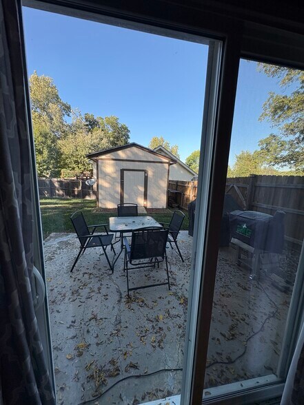Patio outside lower level living room-shed and fenced yard - 10300 W 48th St