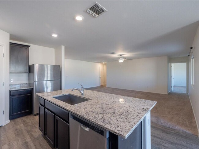 Building Photo - Spacious 4-Bedroom Home with Open Layout & Turf Backyard