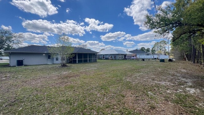 Building Photo - Bright & Spacious 3/2 Home with Huge Yard + Screened Patio — Lawn Care Included!