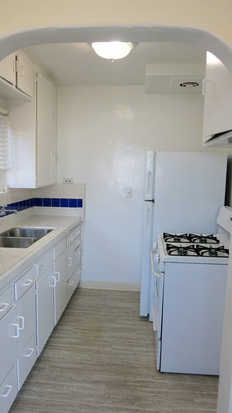 Kitchen-all white with dark blue accent. - 3607 Crest Dr