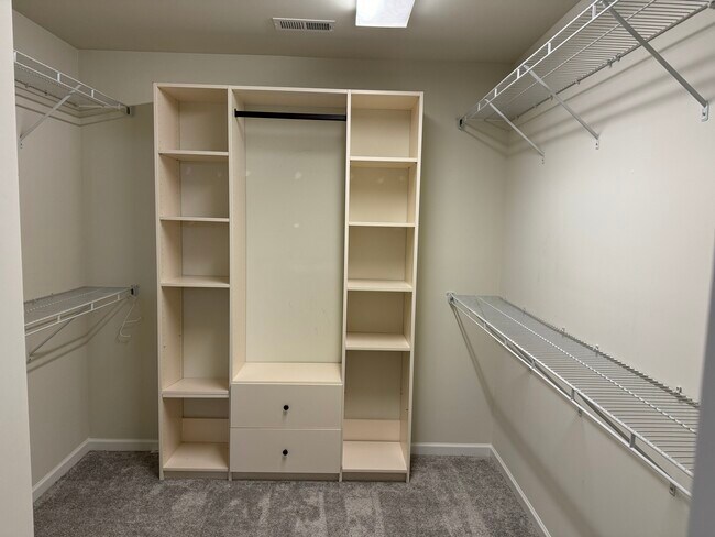 Huge Master closet with custom closets by design - 15656 Canmore St