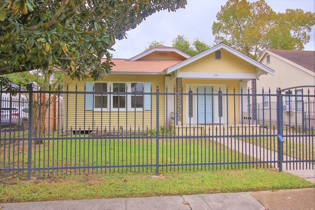 View of fully fenced front yard and main house. - 1127 Walling St