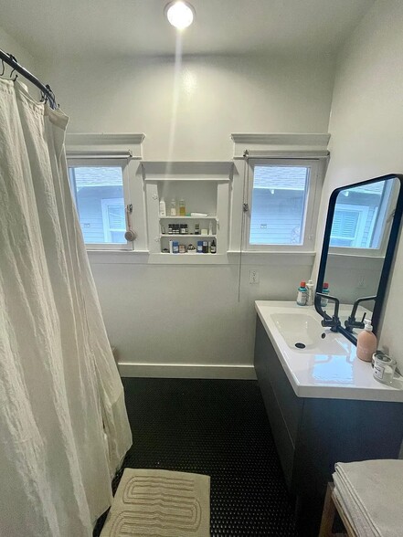 Sunny bathroom with cast iron tub and refreshed finishes. - 6000 Carlton Way