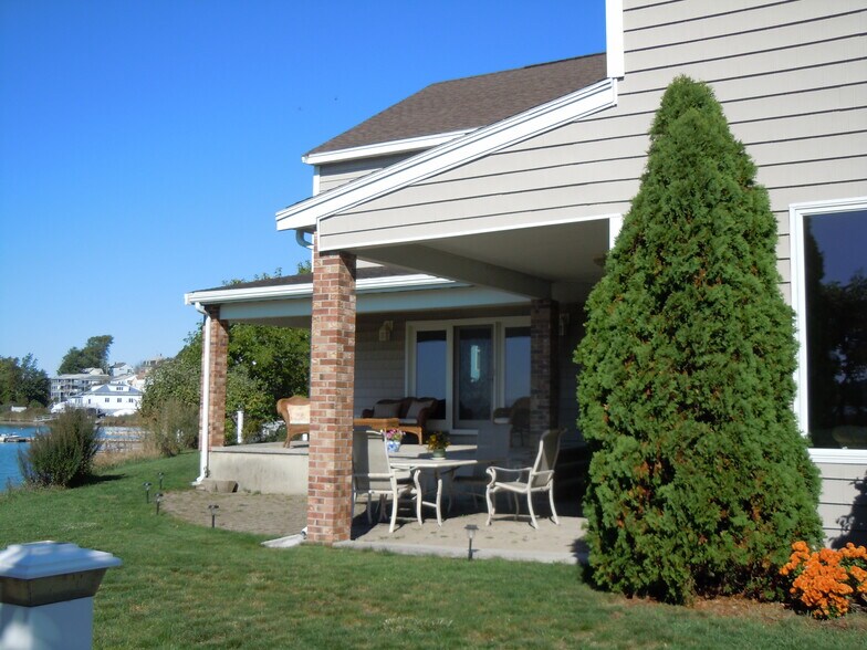 bi-level patio by ocean inlet, with dining table and seating area - 103 Summer St