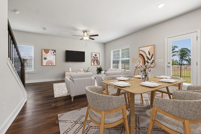 Living room with large window letting in a ton of natural light. - Alma Farms