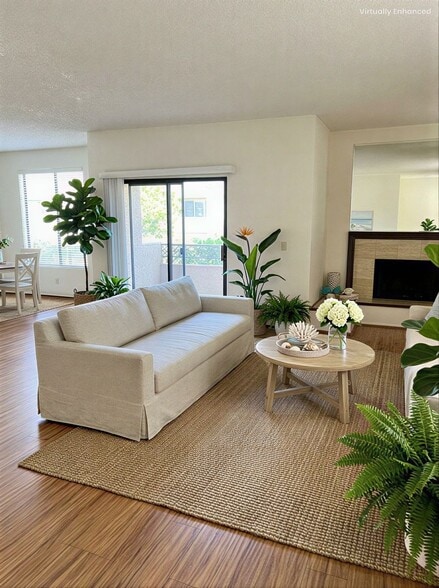Living Room with Decorative Fireplace & Balcony - 4707 Willis Ave