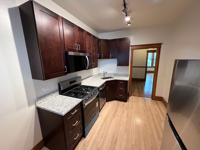 Building Photo - Stunning updated Wrigleyville 4-bed, 3-bath duplex featuring a modern kitchen, renovated baths & ...