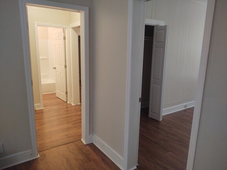 First bedroom on right, entrance to master suite, master bath in the distance - 116 Houseworth St