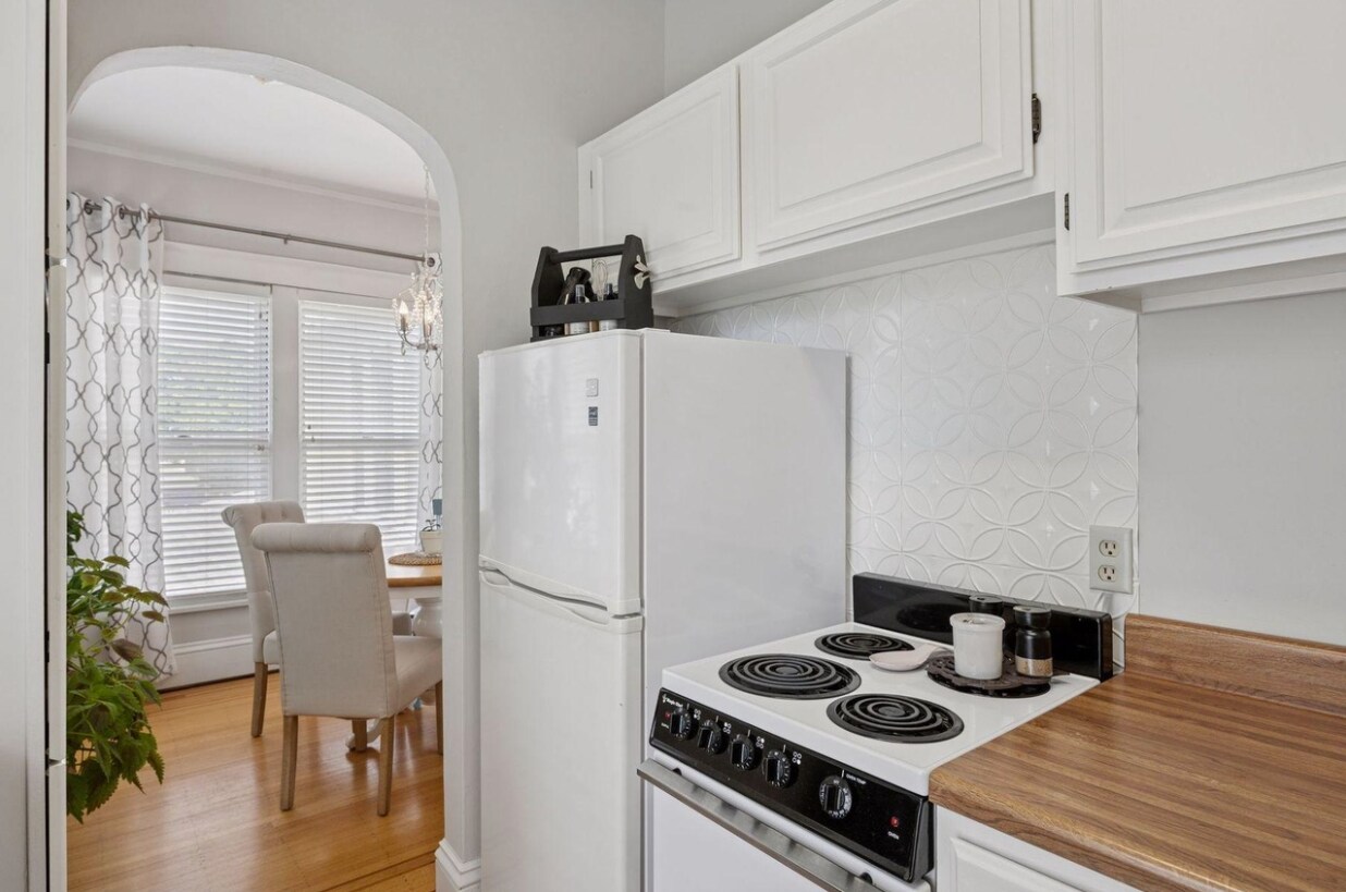 Kitchen, showing off the stovetop/oven, fridge, and even more storage. Comfy, functional kitchen! - 2601 Portland Ave