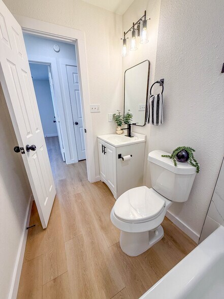 Main bathroom with vinyl plank. - 308 E Bourn St