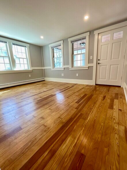 The living room is located at the front of the unit with access to the sunporch. - 20 Chapel St