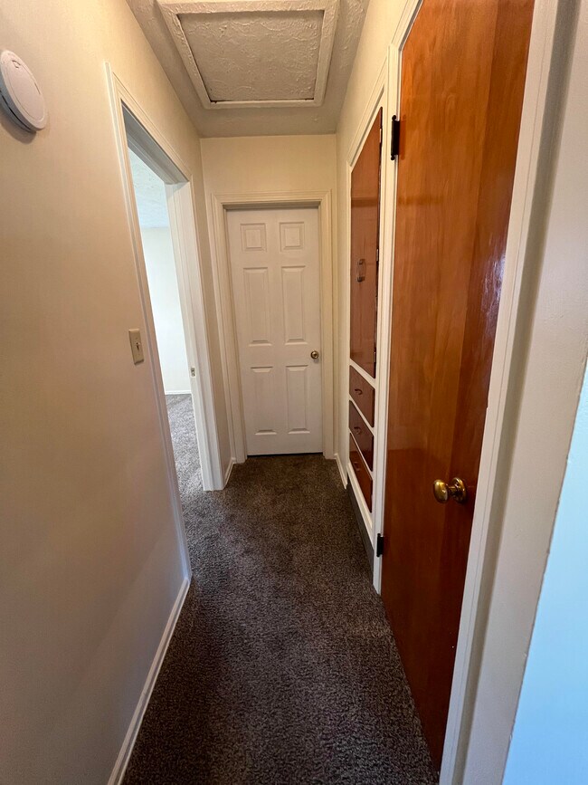 Hallway with coat and linen closets. - 2486 21st St