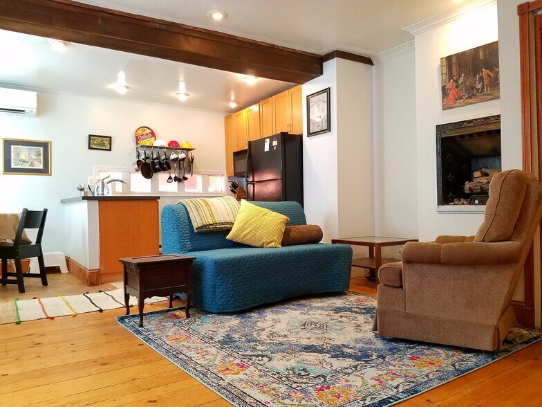 Open living room into kitchen with standard kitchen appliances. - 629 North Bodine Street