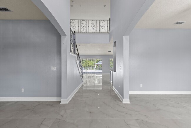 Building Photo - Spacious 6-Bedroom Home Near Lake Nona | 3-Car Garage + Tesla Charger