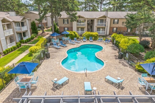 Relax poolside with comfortable lounge chairs and shaded umbrellas at our resort-style swimming pool, professionally operated by Highlands Vista Group. - Ashford Place