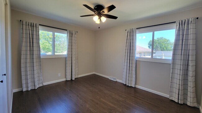 Bedroom 3. Refinished hardwood floors, 4 ft wide closet, new windows and ceiling fan. - 6305 49th Ave