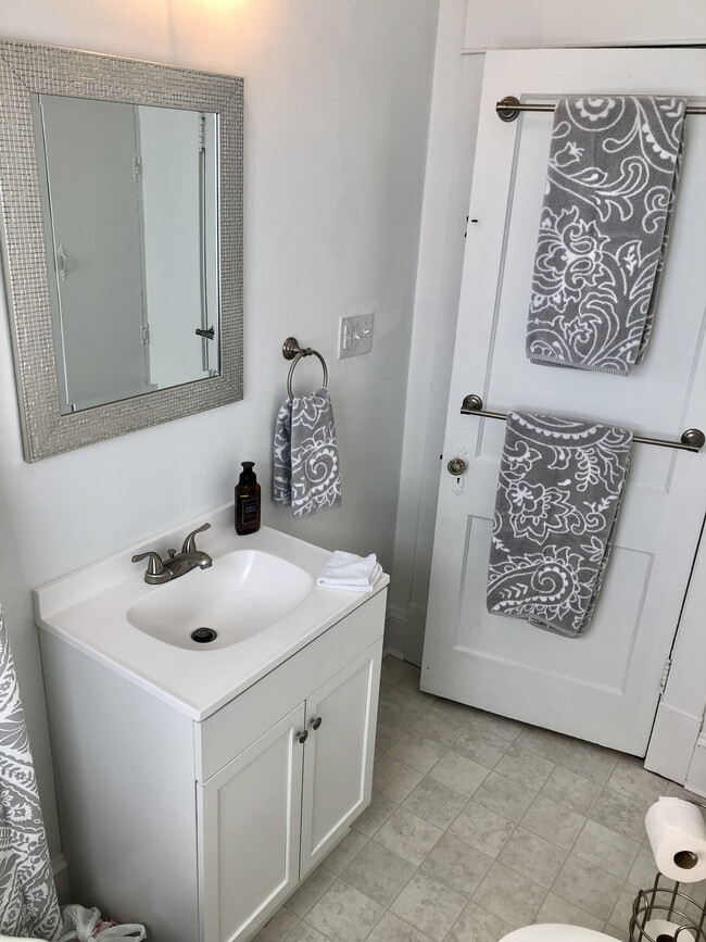 Bathroom with new fixtures and hardware, new plumbing, freshly tiled shower, fresh paint, new floor and large linen closet. - 2205 Mayflower Dr