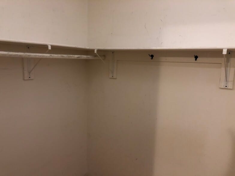 Left side of walk-in closet - 8708 Manchester Rd
