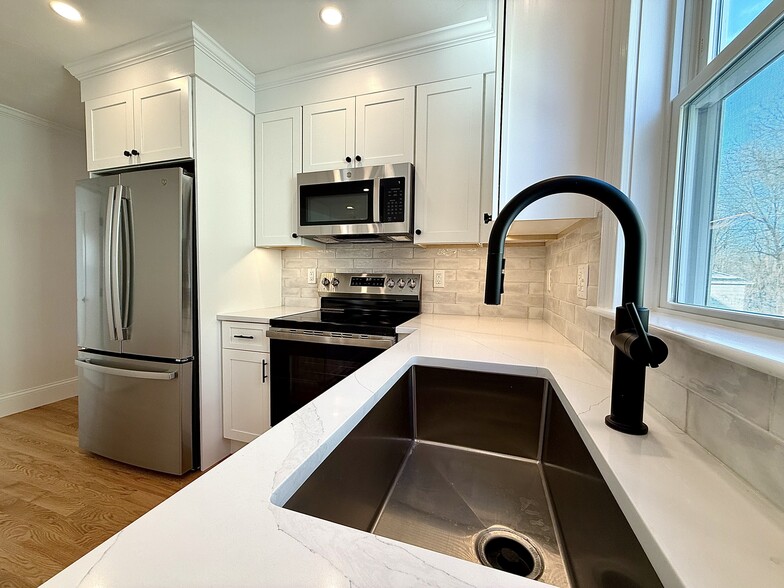 Kitchen: Brand New Stainless Steel Appliances, Quartz Countertops with Open Layout into Living Area - 34 Saint Joseph Ave