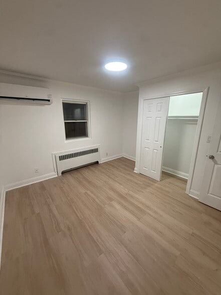Bedroom with mini split, laminate floors & closet - 1120 50th St