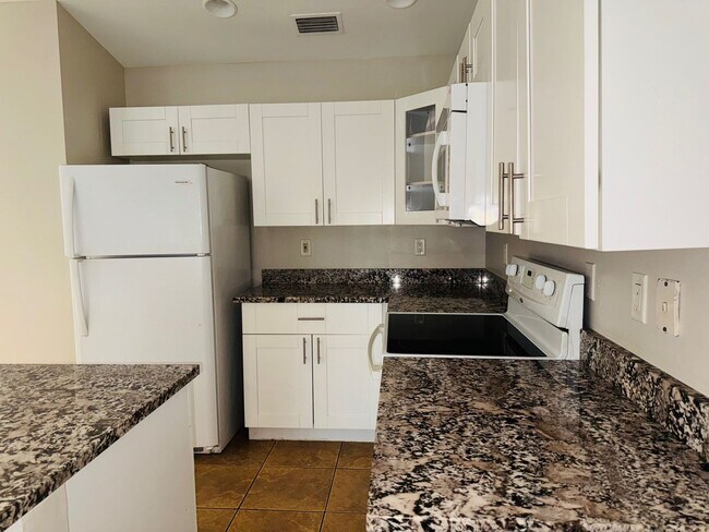 Building Photo - Experience this Cape Coral 3 bedroom 2 bath corner duplex with 1 car garage and screened in lanai.