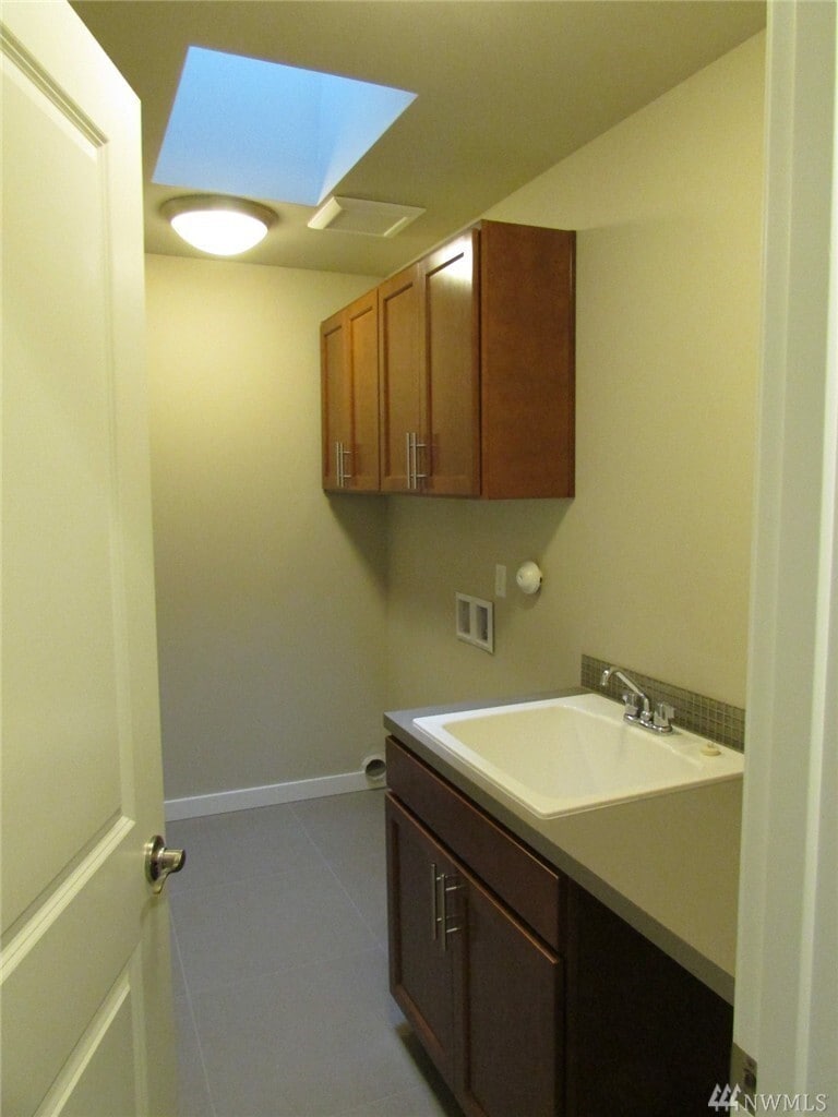 Laundry room. There is a large capacity LG washer and dryer, and there is a large storage closet in the laundry room as well. - 15828 25th Ave NE