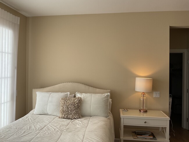 Comfortable bed with cushy pillows and bedding for restful nights. - 150 Sanderling Ln