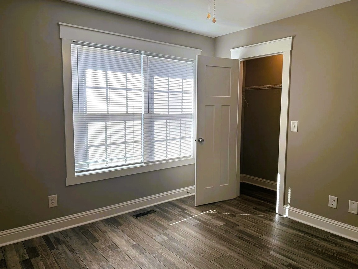 First bedroom with large windows and a closet - 111 Buster Ln