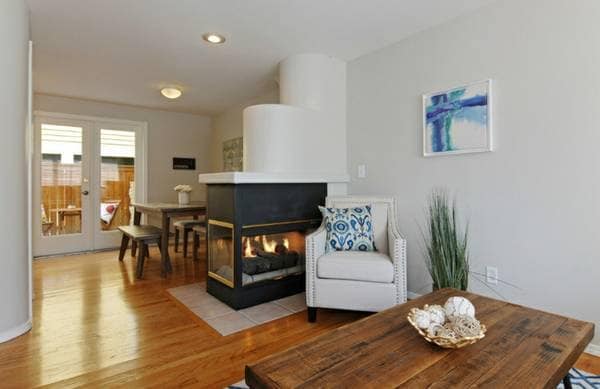 Gas Fireplace separating the Living Room and Dining Room - 6337 Hillman Pl NE