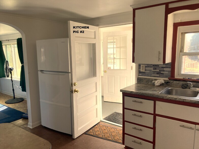 Frige and entrance door to kitchen. - 1589 N Saginaw St