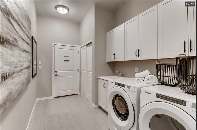 Large laundry room with washer/dryer, sink and lots of storage - 12538 Lake Trail St