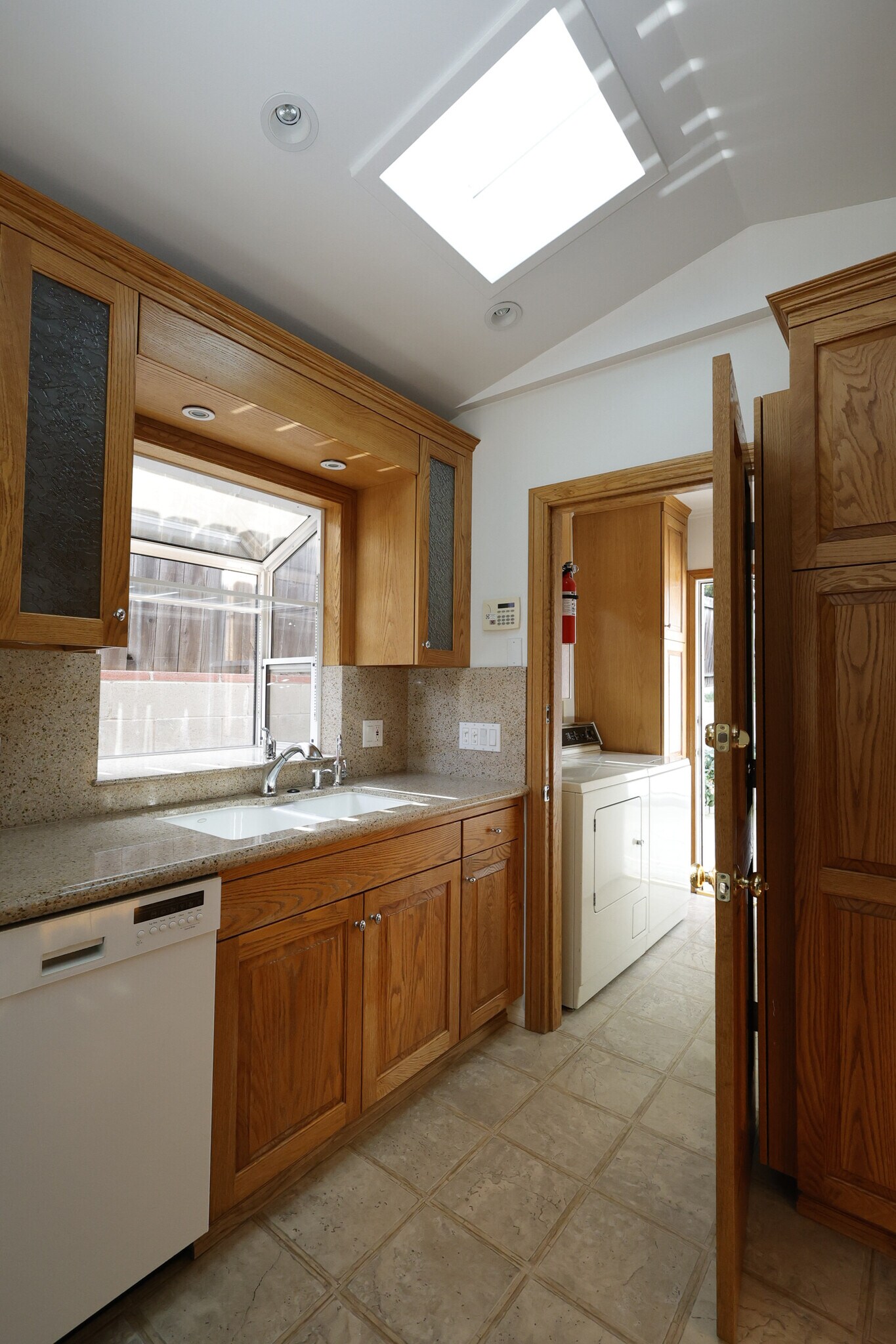 Kitchen sink with adjacent laundry room makes for efficient flow of house work - 4831 Canoga Ave