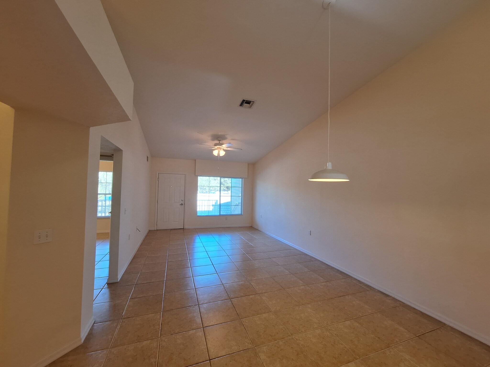 Living room has vaulted ceiling, ceiling fan/light, window minblinds - 25727 Lake Amelia Way