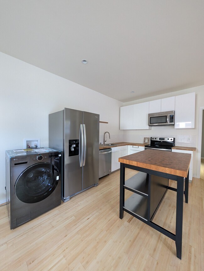 Kitchen with adjacent LG ComboWash Washer and Dryer - 530 Tompkins Ave
