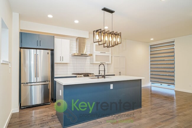 Building Photo - Rooftop Living with Open Concept Design and Parking Included