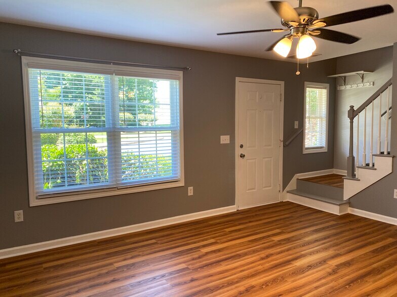 Living room has plenty of space, ceiling fan and vinyl plank flooring. - 1305 Cedar Shoals Drive #500
