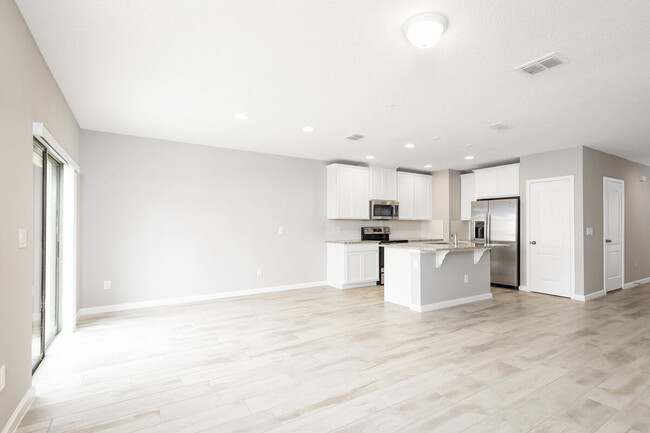 Open living space with new, 48" cabinets, pantry and GE stainless appliances - 14799 Outfitter St