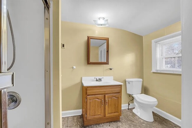 bathroom with tub and large closet - 24 Lancaster Rd