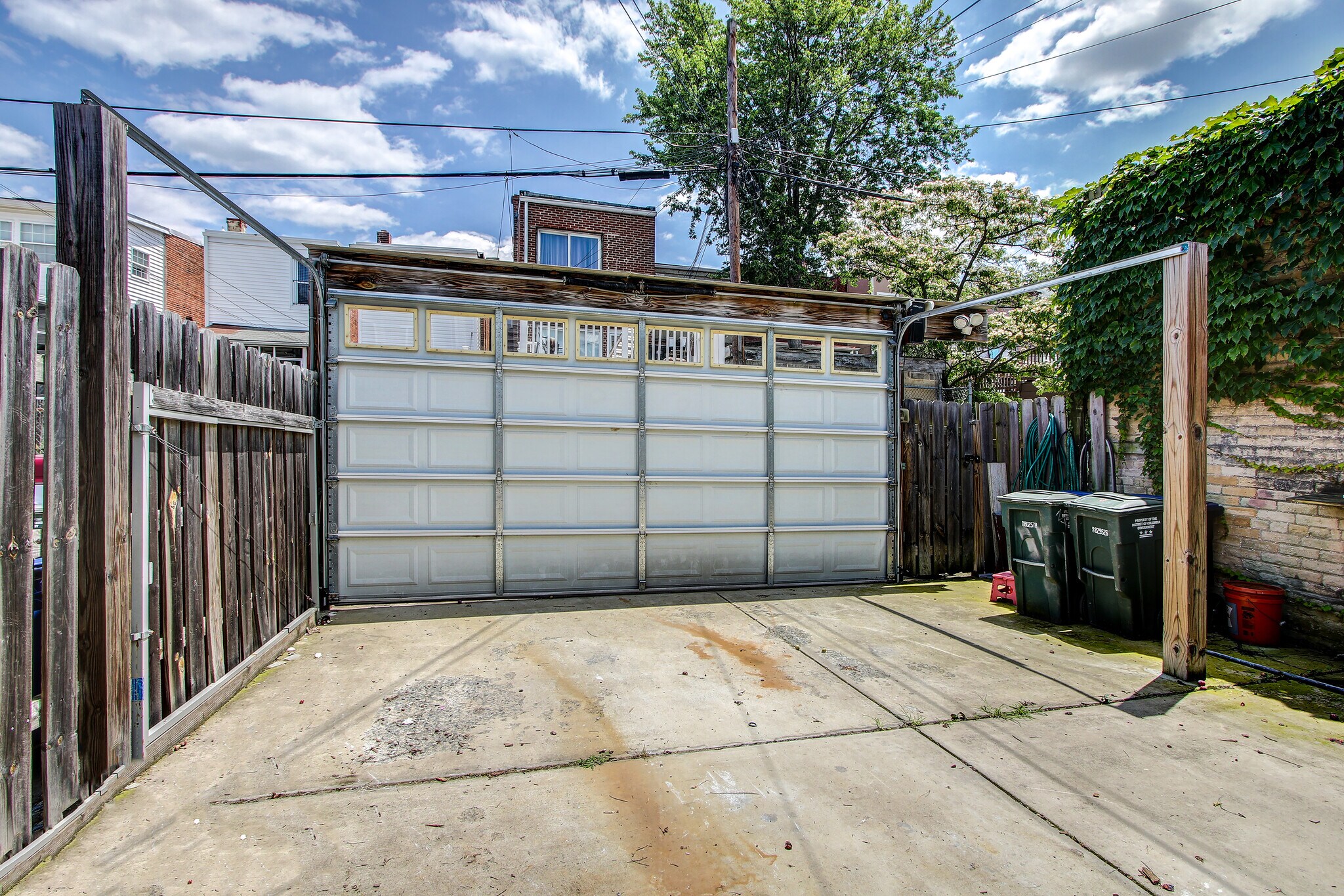 Parking pad with garage door - 3539 Holmead Pl NW