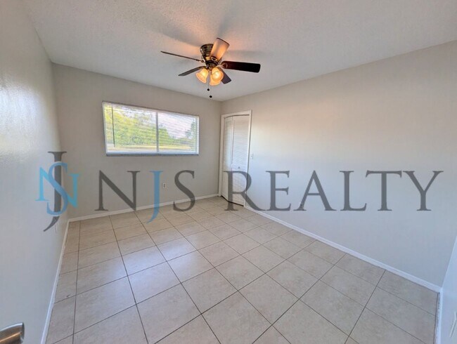 Building Photo - JUST REDUCED!!!  3/2/2 1500 Sq. Ft. with fenced yard, tile floors, HUGE living room and a corner ...