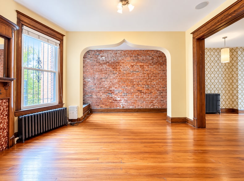Spacious dining room featuring original hardwood floors and unique arch - 2322 1st St NW
