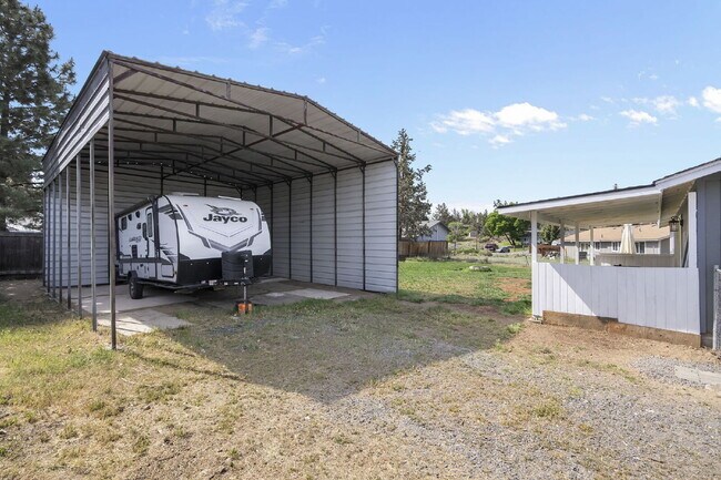Building Photo - Charming 3-Bedroom Bend Home on 1/2 Acre with Expansive Yard, Mature Trees & Covered RV/Boat Storage