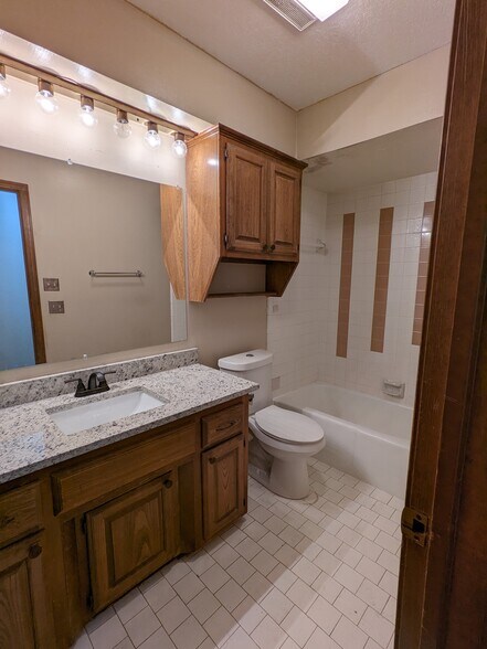 Hallway Bathroom with New granite countertop, toilet and fixtures - 1616 Julie Plz