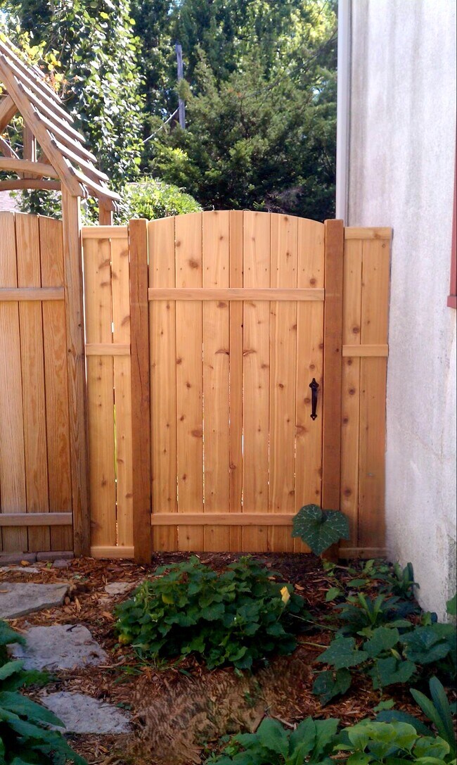 Private gate leading to the fenced backyard. - 2923 Arthur St NE