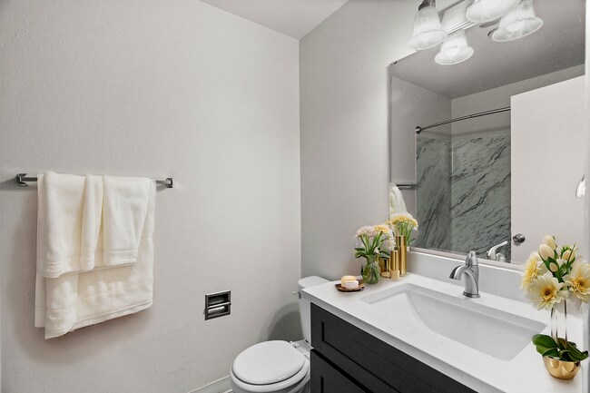 Experience serenity in this elegantly designed bathroom, complete with luxurious features. - University Crossing Apartments
