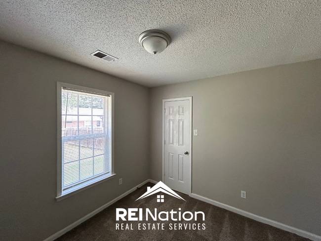 Building Photo - Spacious 4BR/2BA Near Southwind | High Ceilings, Brick Fireplace & 2-Car Garage
