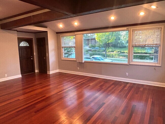 Living room with vaulted ceilings, exposed beams, and recessed lighting - 2417 W 22nd St