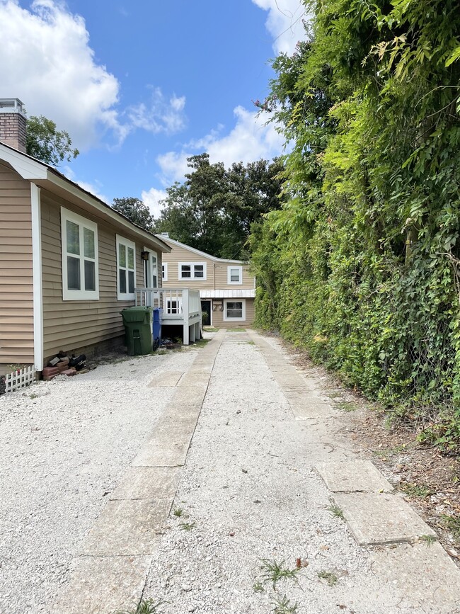 Walking up driveaway (street parking only). Main house to the left (front) and duplex in the back - 157 Northern Blvd